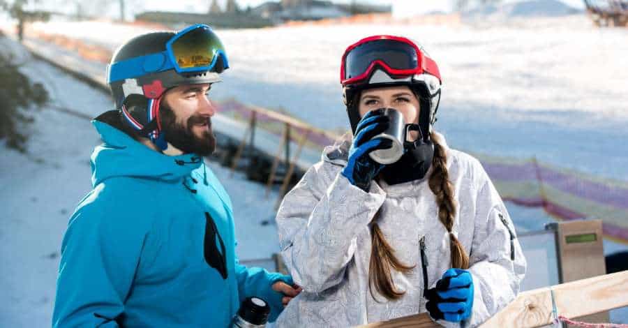 snowboarder and skier drinking