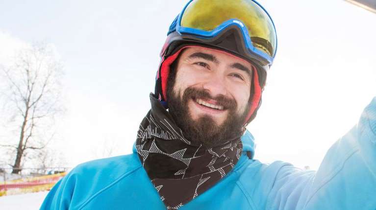 man on ski mountain with neck warmer