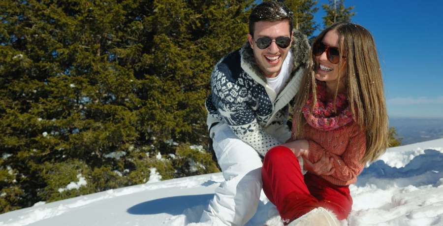 happy couple on a snowy ski mountain happy couple on a snowy ski mountain